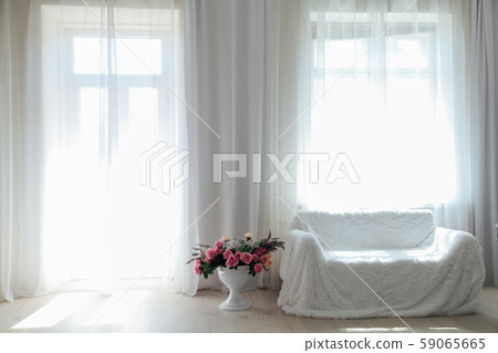 Interior white room sofa flowers light from the window Interior white room sofa flowers light from the window 59065665