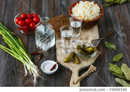 Vodka and traditional snack on wooden background Vodka and traditional snack on wooden background 59066588