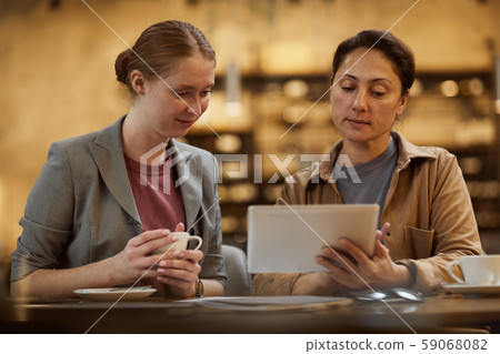 Businesswomen using digital tablet 59068082