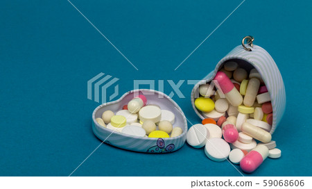 iron heart box for tablets on a blue background. round, oval, white, red. close-up 59068606