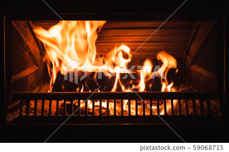 Burning firewood in a fireplace Burning firewood in a fireplace 59068715