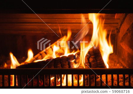 Firewood burning in a fireplace 59068716