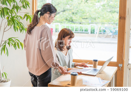 Two young women having an office image Two young women having an office image 59069100