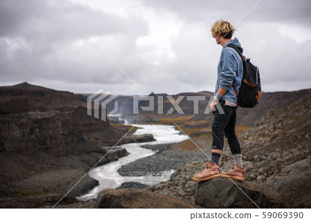 Hiker standing at the edge of a Valley in Vatnajokull National Park in Iceland 59069390
