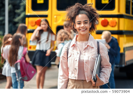 Classmates going to school by bus african girl close-up with book smiling cheerful Classmates going to school by bus african girl close-up with book smiling cheerful 59073904