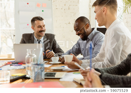 Group of young business professionals having a meeting, creative office Group of young business professionals having a meeting, creative office 59075529