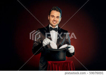 Professional Occupation. Magician in suit and gloves standing isolated on wall making trick taking Professional Occupation. Magician in suit and gloves standing isolated on wall making trick taking 59076091