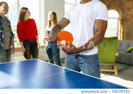 Young people playing table tennis in workplace, having fun 59076593