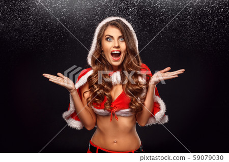 Christmas and New Year. Woman in santa costume standing isolated on black screaming to camera 59079030
