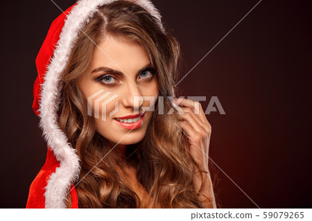 Christmas and New Year. Woman in santa costume with hood standing isolated on black smiling happy 59079265