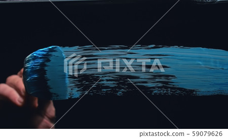 The artist draw on glass. Back view. Craftsman decorator use large brush, blue acrylic oil paint The artist draw on glass. Back view. Craftsman decorator use large brush, blue acrylic oil paint 59079626