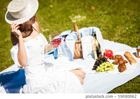 Portrait of happy young woman having rest on picnic in park Portrait of happy young woman having rest on picnic in park 59080062