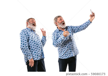 Senior man arguing with himself on white studio background. Senior man arguing with himself on white studio background. 59080173