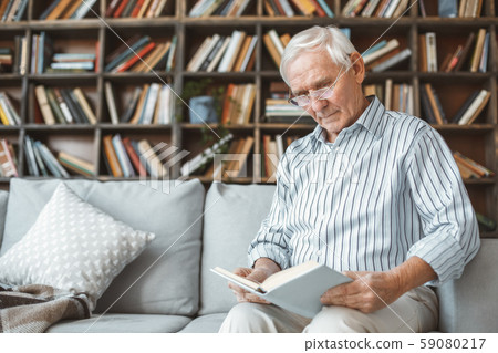 Senior man at home retirement concept sitting reading book 59080217
