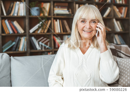 Senior woman at home retirement concept sitting smartphone communication close-up Senior woman at home retirement concept sitting smartphone communication close-up 59080226