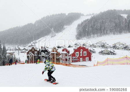 The skiers and snowborders are on slope in Bukovel ski resort, Ukraine 59080268