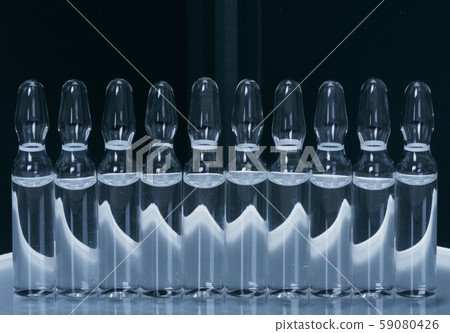 Glass medical ampoule vial for injection. Medicine is liquid sodium chloride with of aqueous Glass medical ampoule vial for injection. Medicine is liquid sodium chloride with of aqueous 59080426