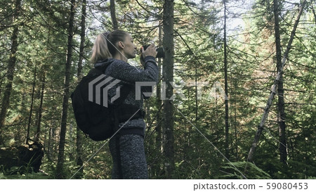 Traveler photographing scenic view in forest. One caucasian woman shooting nice magic look. Girl Traveler photographing scenic view in forest. One caucasian woman shooting nice magic look. Girl 59080453