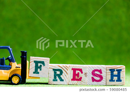Forklift hold wood letter block F to complete word fresh 59080485