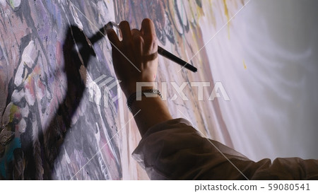 Artist designer draws an eagle on the wall. Craftsman decorator paints a picture with acrylic oil 59080541