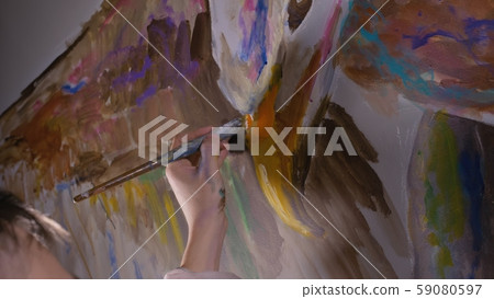 Artist designer draws an eagle on the wall. Craftsman decorator paints picture with acrylic oil Artist designer draws an eagle on the wall. Craftsman decorator paints picture with acrylic oil 59080597
