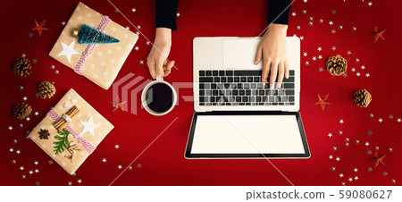 Christmas ornaments with person using a laptop computer Christmas ornaments with person using a laptop computer 59080627