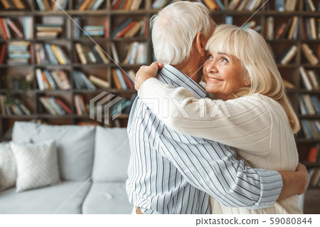 Senior couple together at home retirement concept dancing ballroom dance hugging cheerful 59080844