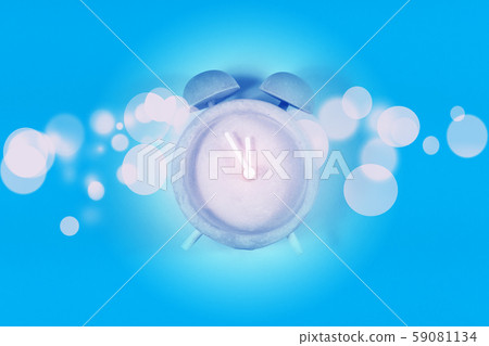 countdown time on alarm clock and vivid bokeh on blue background countdown time on alarm clock and vivid bokeh on blue background 59081134