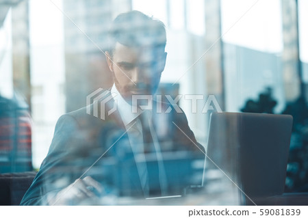 Businessman sitting in a business center restaurant with laptop indistinct view Businessman sitting in a business center restaurant with laptop indistinct view 59081839