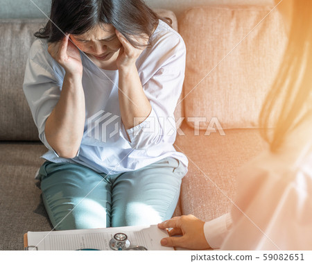 Headache, migraine patient, stressful depressed menopause ageing woman with anxiety disorder 59082651