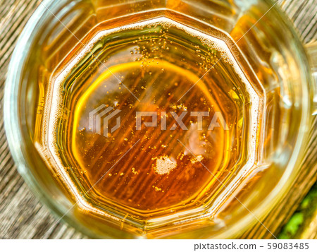 beer in a mug on top with bubbles 59083485