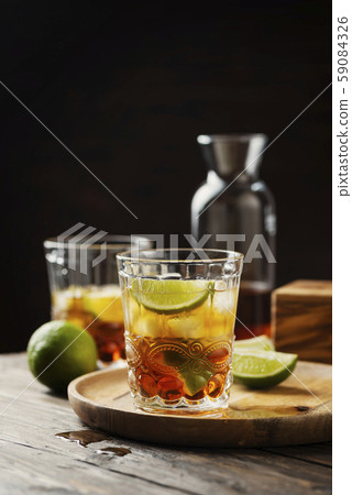Strong golden rum with lime and ice Strong golden rum with lime and ice 59084326