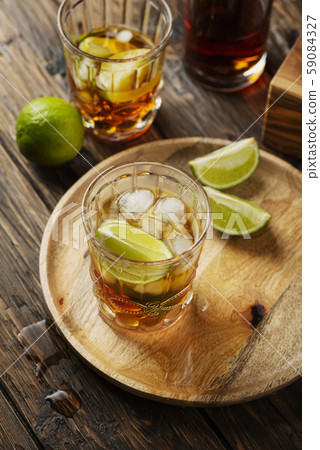 Strong golden rum with lime and ice Strong golden rum with lime and ice 59084327