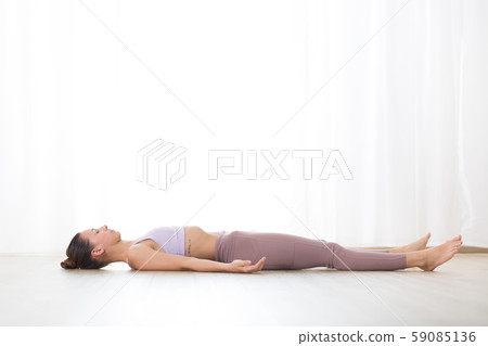 Portrait of gorgeous active sporty young woman practicing yoga in studio. Beautiful girl relaxing in 59085136