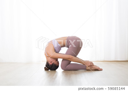 Portrait of gorgeous active sporty young woman practicing yoga in studio. Beautiful girl practice Portrait of gorgeous active sporty young woman practicing yoga in studio. Beautiful girl practice 59085144