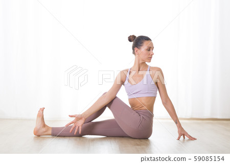 Portrait of gorgeous active sporty young woman practicing yoga in studio. Beautiful girl practice Portrait of gorgeous active sporty young woman practicing yoga in studio. Beautiful girl practice 59085154