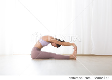 Portrait of gorgeous active sporty young woman practicing yoga in studio. Beautiful girl practice Portrait of gorgeous active sporty young woman practicing yoga in studio. Beautiful girl practice 59085158