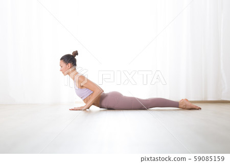Portrait of gorgeous active sporty young woman practicing yoga in studio. Beautiful girl practice 59085159