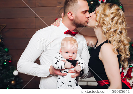 Elegance family standing together near fireplace 59085641