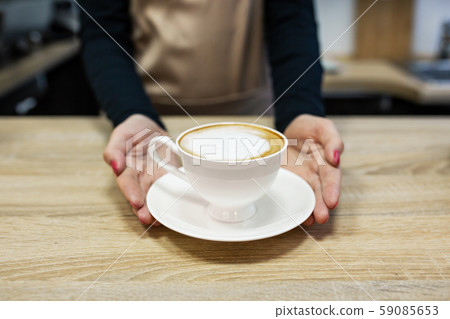 Barista brings fresh delicious coffee close up Barista brings fresh delicious coffee close up 59085653