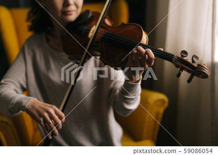 Beautiful young woman musician playing the violin close-up Beautiful young woman musician playing the violin close-up 59086054