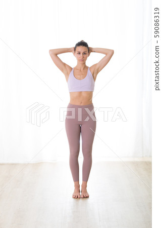 Portrait of gorgeous active sporty young woman practicing yoga in studio. Beautiful girl practice 59086319