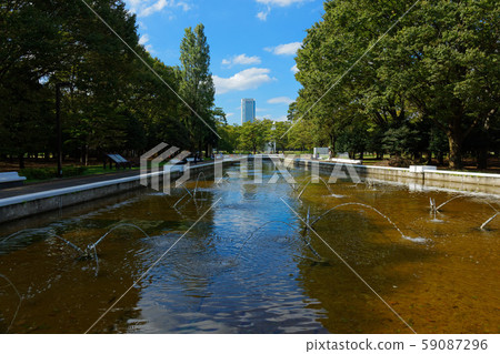Yoyogi Park fountain, Shinjuku Opera City and blue sky Yoyogi Park fountain, Shinjuku Opera City and blue sky 59087296