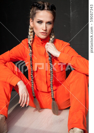 portrait of a beautiful woman in an orange jumpsuit portrait of a beautiful woman in an orange jumpsuit 59087343