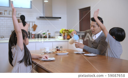 Holiday concept. The family is having breakfast Holiday concept. The family is having breakfast 59087658