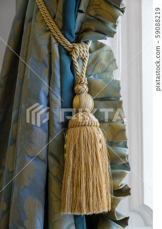 Luxury tassel in golden color close up and curtain Luxury tassel in golden color close up and curtain 59088219