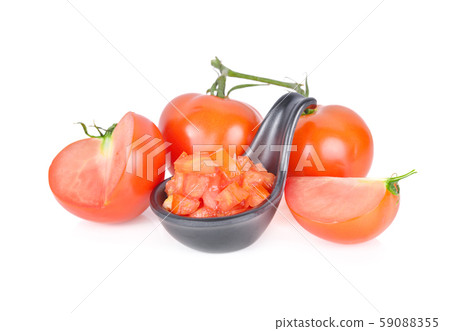 whole and cut cube tomato in black spoon and haf whole and cut cube tomato in black spoon and haf 59088355
