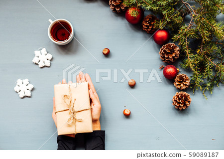 Christmas decorations hand amid Christmas trees and gifts 59089187