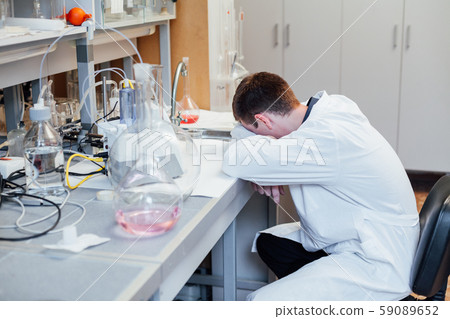 scientist in the medical lab sleeps in the workplace 59089652