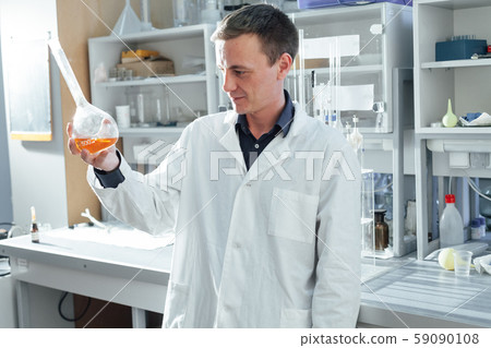 scientist in the medical laboratory conducts chemical experiments with liquids 59090108